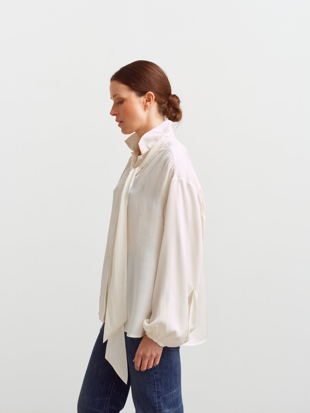 Caen blouse in cloud dancer silk blend, side view showing balloon sleeves and the scarf hanging loose