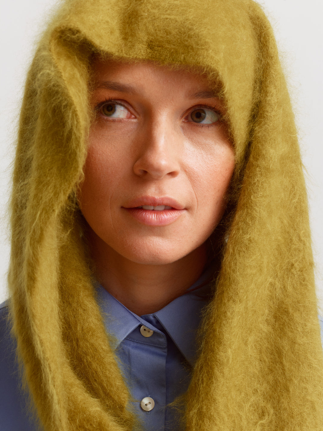 Chamonix scarf in fresh moss brushed cashmere, draped over the head and shoulders