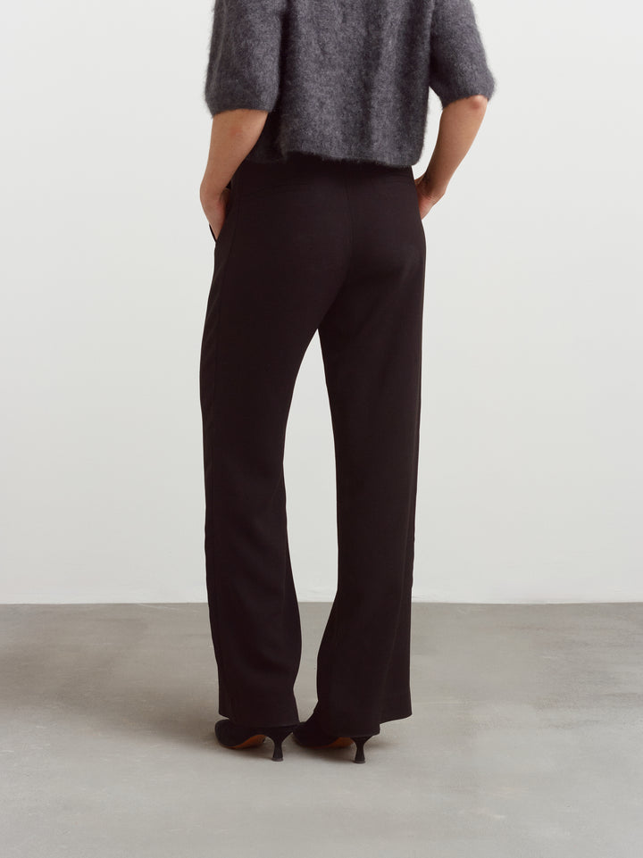 Helsinki suit pant in black acetate, back view showing the elongated silhouette