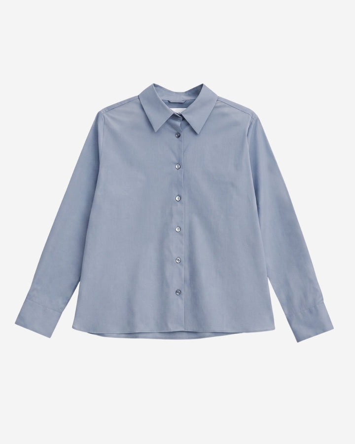 Lyon shirt in Monday blue organic cotton, flat lay with pointed collar and button-down front