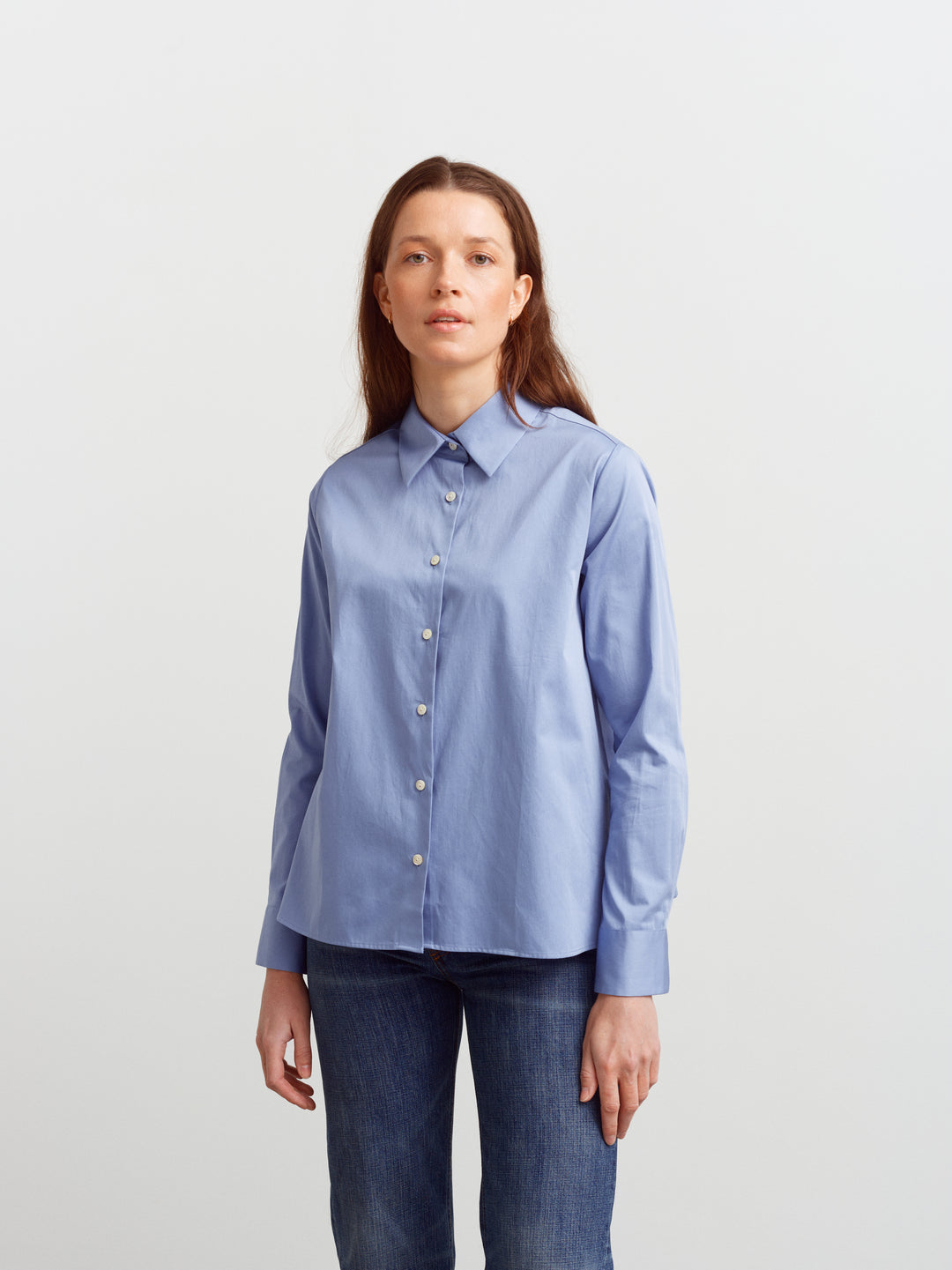 Lyon shirt in Monday blue organic cotton, front view buttoned over denim
