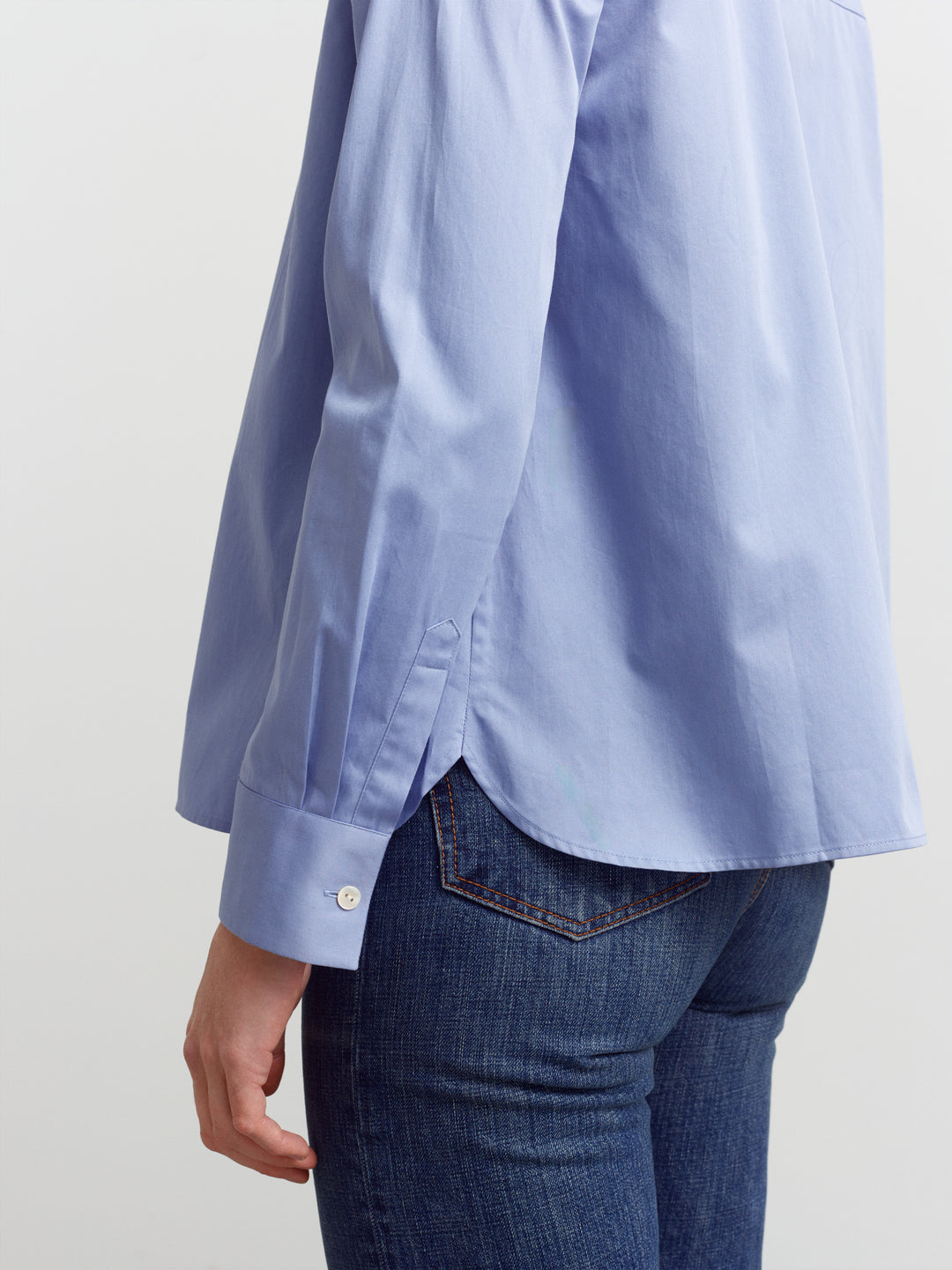 Lyon shirt in Monday blue organic cotton, side view showing the A-line shape at the hem