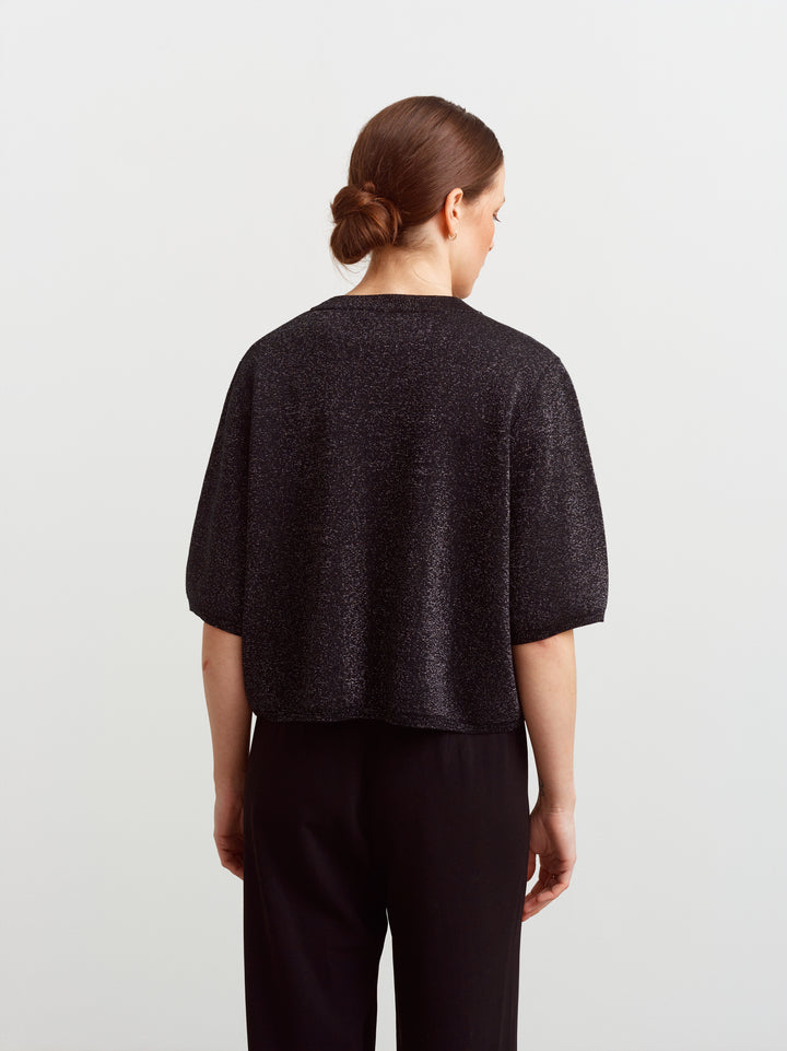 Modena tee in black glow metallic knit, back view showing slightly boxy fit
