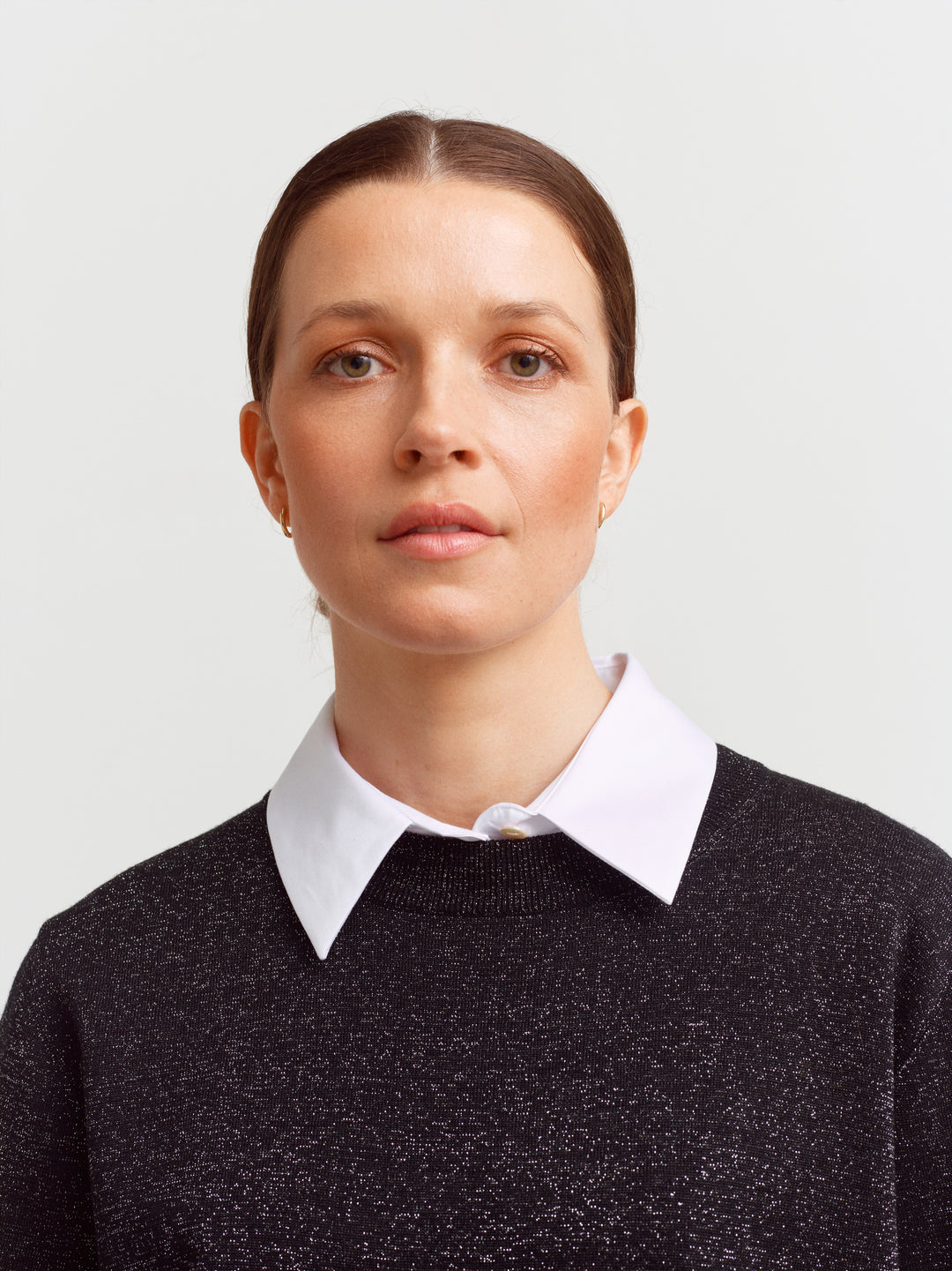 Modena tee in black glow, close-up of round neckline and metallic lurex threads
