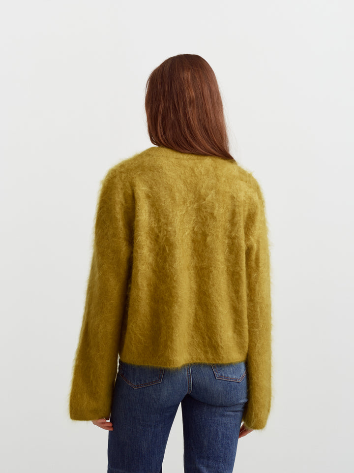 Montreal sweater in fresh moss brushed cashmere, back view showing relaxed fit over denim