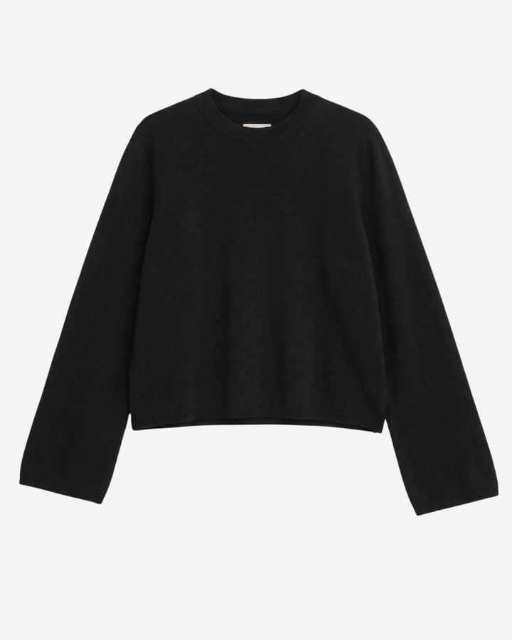 Montreal sweater in black merino wool, flat lay showing crew neckline and straight fit