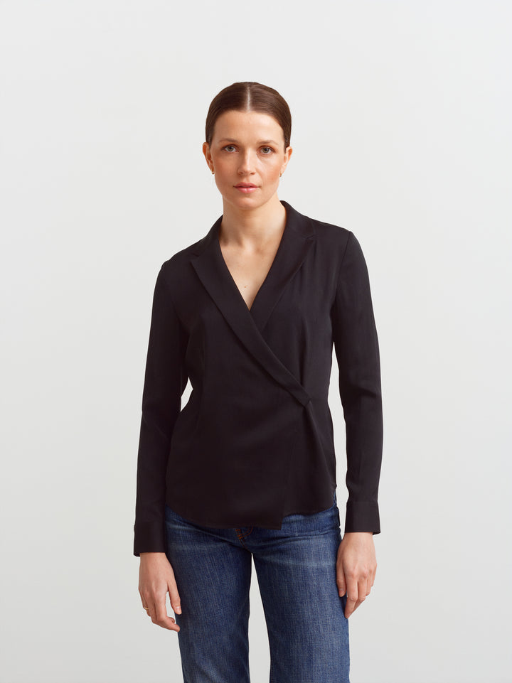 New York blouse in black silk blend, front view showing shaping through the waist over denim