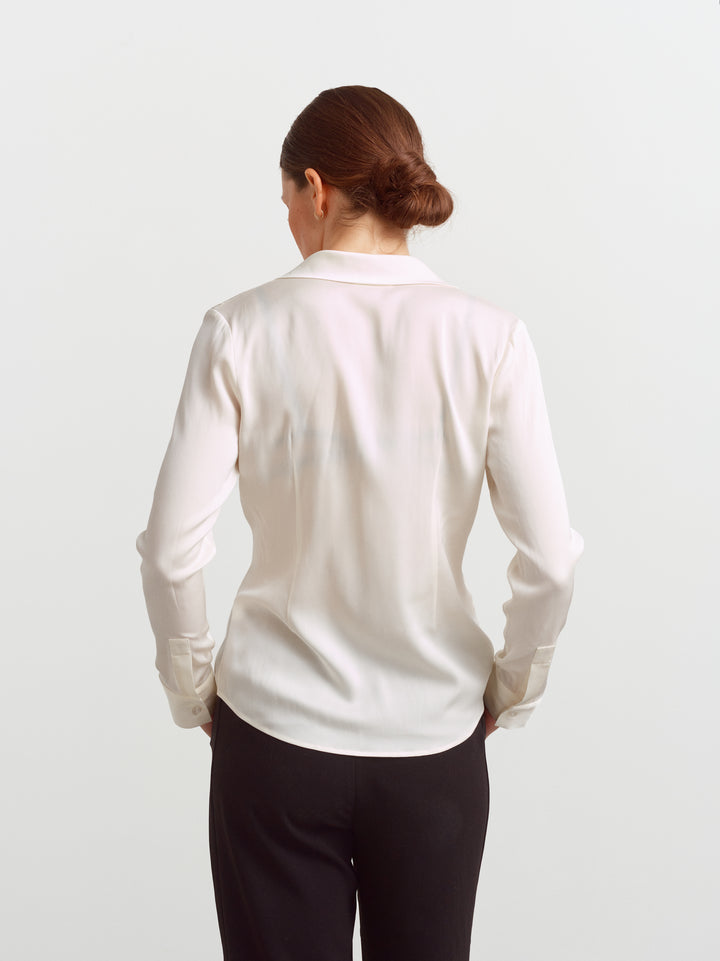 New York blouse in cloud dancer silk blend, back view showing fluid drape and shaping at the waist