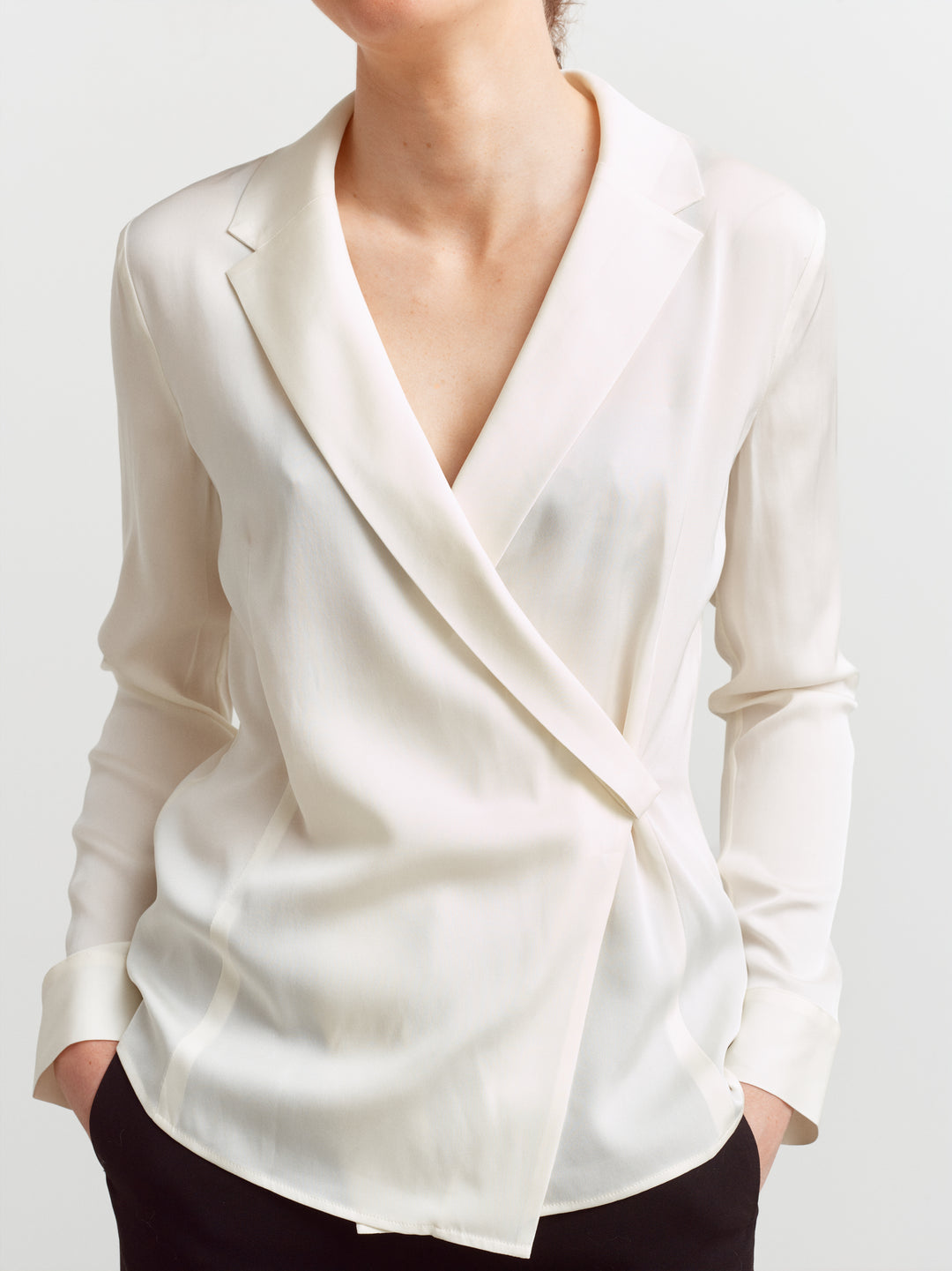 New York blouse in cloud dancer silk blend, close-up of draped wrap front and notched lapel collar