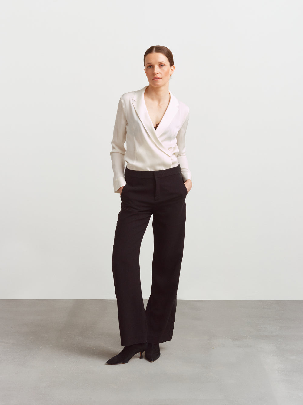 New York blouse in cloud dancer silk blend, wrap front, worn with black tailored trousers