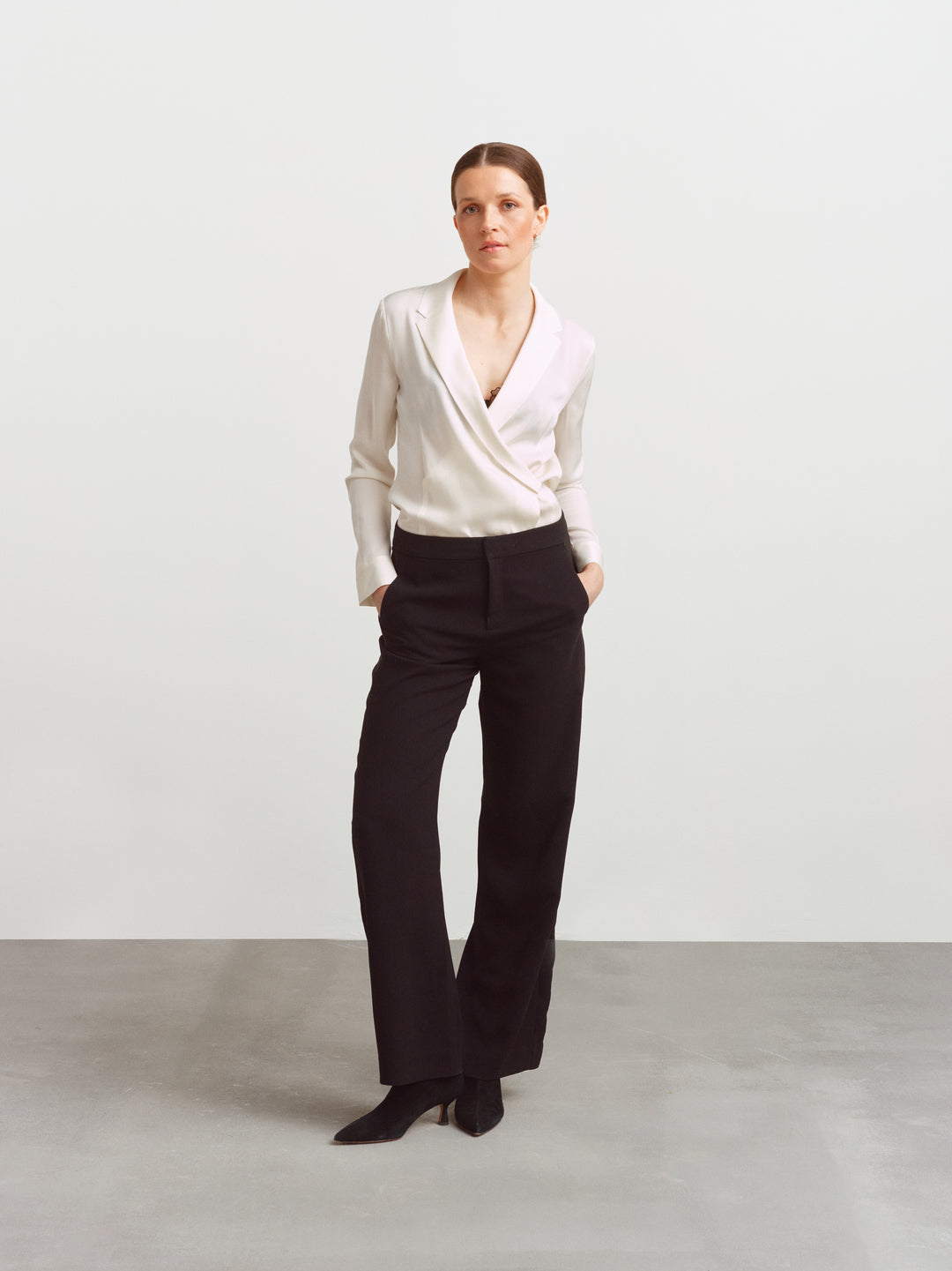 New York blouse in cloud dancer silk blend, wrap front, worn with black tailored trousers