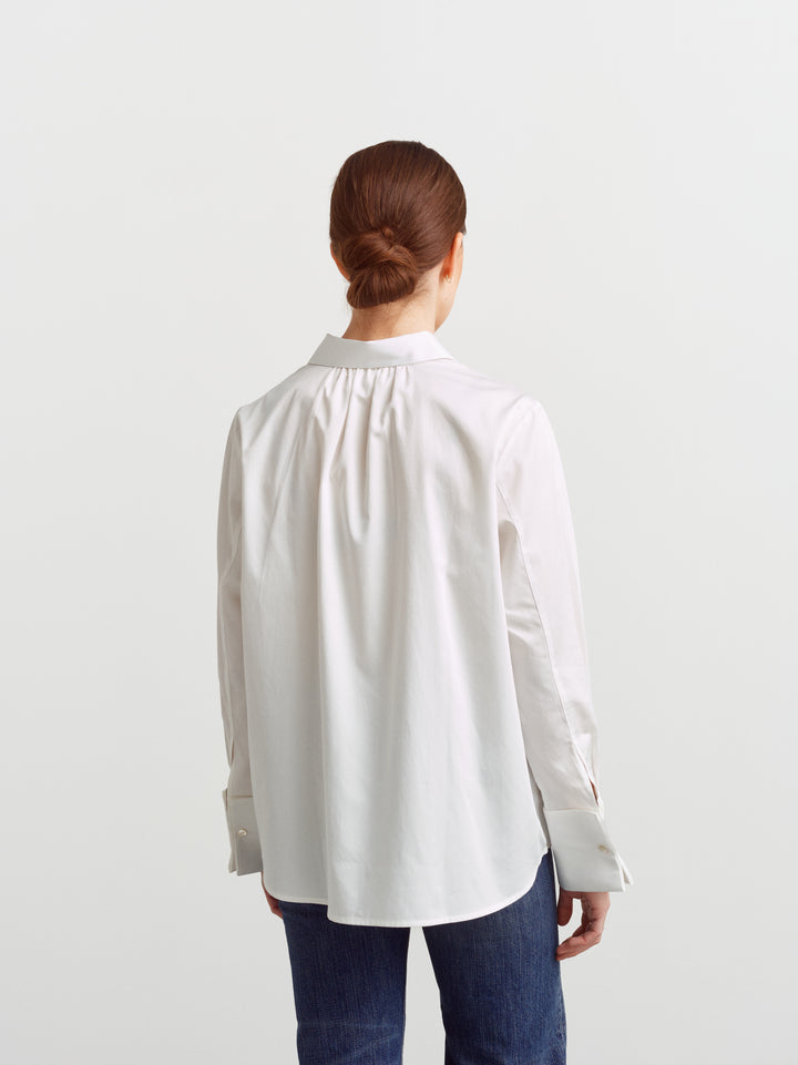 Odense shirt in white organic cotton, back view with gathered yoke and curved hem