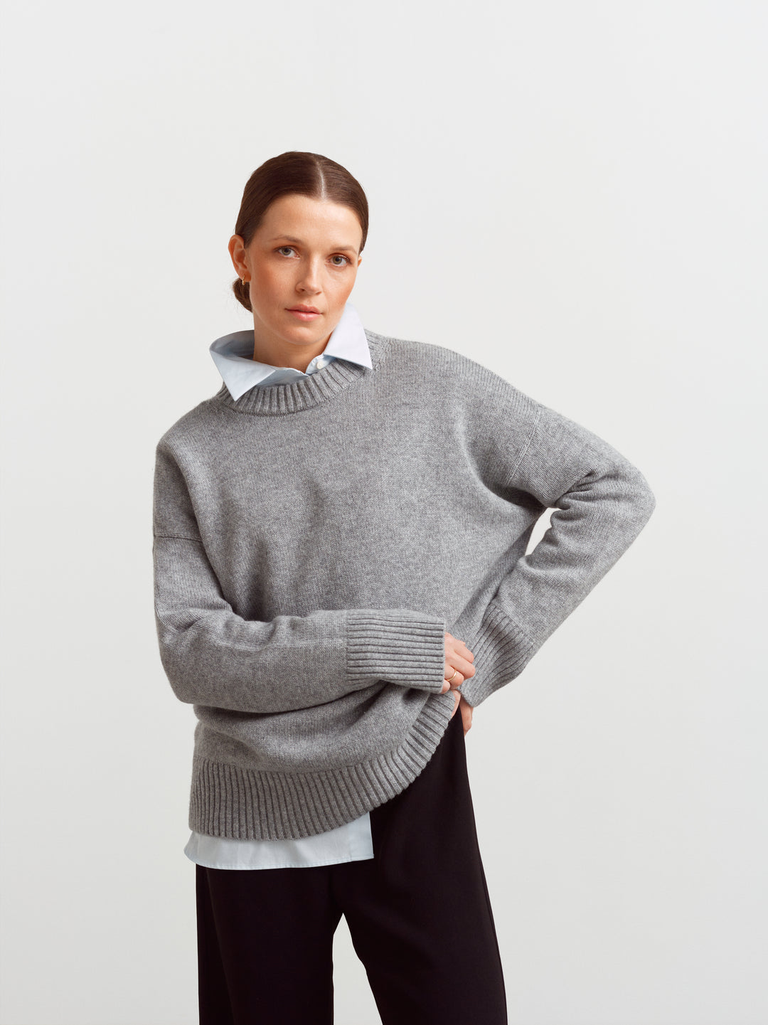 Varese wool cashmere sweater in mineral grey, layered over a white shirt with black trousers