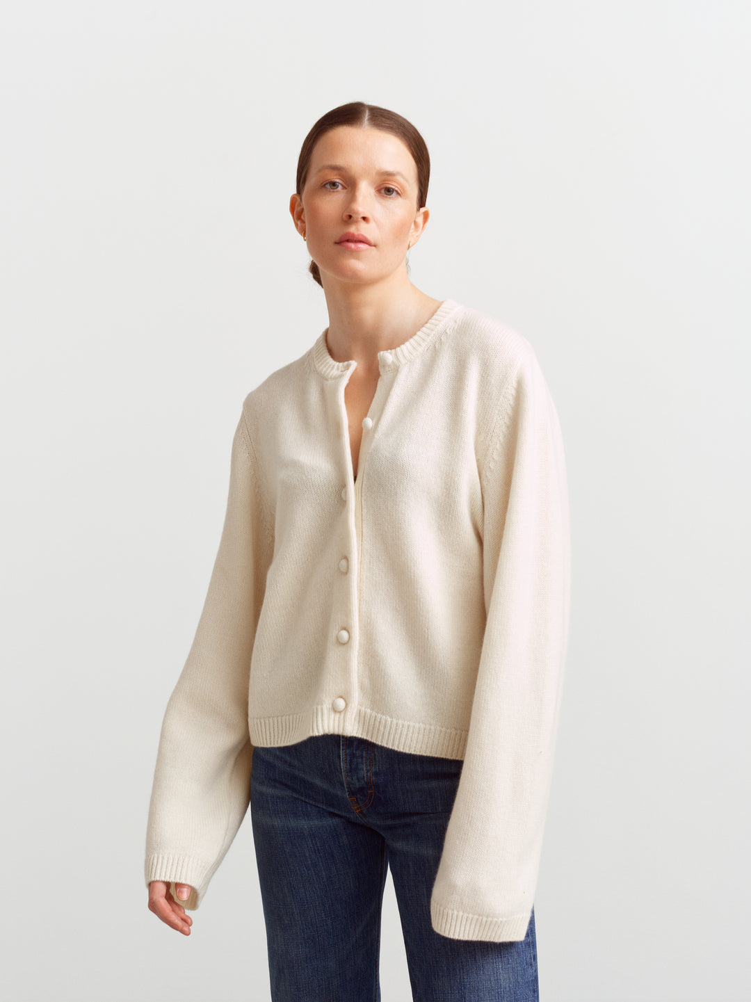 Verona cardigan in cloud dancer, front view buttoned with sleeves resting at the wrist